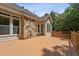 Spacious wooden deck with stone feature on home's exterior, and wooded back yard at 2709 Penfold Ln, Wake Forest, NC 27587