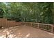Spacious wooden deck with railing overlooking a lush, green backyard with mature trees at 2709 Penfold Ln, Wake Forest, NC 27587