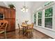 Dining area showcasing ample natural light from large windows and access to the kitchen at 2709 Penfold Ln, Wake Forest, NC 27587