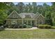 Charming stone-accented home with manicured lawn and lush landscaping creating great curb appeal at 2709 Penfold Ln, Wake Forest, NC 27587
