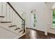 Bright foyer with dark hardwood floors, staircase, and glass door offering a welcoming entrance at 2709 Penfold Ln, Wake Forest, NC 27587