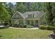 Charming stone and siding home with a well-manicured lawn and inviting front porch at 2709 Penfold Ln, Wake Forest, NC 27587