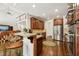 Kitchen featuring stainless appliances, granite countertops, breakfast bar, and access to the upper floor at 2709 Penfold Ln, Wake Forest, NC 27587