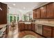 Gourmet kitchen featuring dark wood cabinets, stainless steel appliances, and an open dining area at 2709 Penfold Ln, Wake Forest, NC 27587