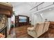 Living room features a stone fireplace, upper floor access, and built-in entertainment center at 2709 Penfold Ln, Wake Forest, NC 27587
