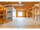 Spacious unfinished basement with window and wood framing, perfect for customization at 2727 Masonboro Ferry Dr, Apex, NC 27502