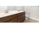 Bathroom with double vanity, dark wood cabinets, and a toilet with tiled floors at 2727 Masonboro Ferry Dr, Apex, NC 27502