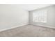 Bedroom with neutral carpet and walls, double-hung window and white trim at 2727 Masonboro Ferry Dr, Apex, NC 27502