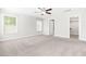 Large bedroom with neutral carpeting, a ceiling fan and an open door leading to the walk-in closet at 2727 Masonboro Ferry Dr, Apex, NC 27502