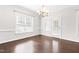 Dining room with hardwood floors, white walls, double-hung windows and direct outside access at 2727 Masonboro Ferry Dr, Apex, NC 27502