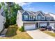 Charming townhome showcasing well-maintained landscaping, attached garage, and inviting curb appeal at 2727 Masonboro Ferry Dr, Apex, NC 27502