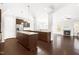 Open concept kitchen with granite countertops, an island, stainless steel appliances, and dark hardwood floors at 2727 Masonboro Ferry Dr, Apex, NC 27502