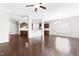 Open-concept living room with hardwood floors, white walls, and views of the kitchen with modern cabinetry at 2727 Masonboro Ferry Dr, Apex, NC 27502