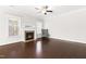 Bright living room with fireplace, hardwood floors, large windows, and a gray chair at 2727 Masonboro Ferry Dr, Apex, NC 27502
