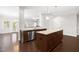 Open-concept living space with hardwood floors, a fireplace, and natural light at 2727 Masonboro Ferry Dr, Apex, NC 27502