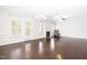 Bright living room with hardwood flooring, a fireplace, and large windows offering ample natural light at 2727 Masonboro Ferry Dr, Apex, NC 27502