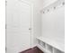 Mud room with white walls, coat hooks, storage bench and shoe storage at 2727 Masonboro Ferry Dr, Apex, NC 27502