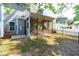 Rear view of home with a screened porch overlooking a fenced backyard at 2727 Masonboro Ferry Dr, Apex, NC 27502
