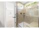 Tiled glass shower with built-in shelves and a bench, offering a luxurious bathing experience at 2727 Masonboro Ferry Dr, Apex, NC 27502