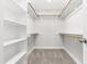 Spacious walk-in closet with carpeted floors, built-in shelves, and multiple racks for hanging clothes at 2727 Masonboro Ferry Dr, Apex, NC 27502