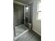 Walk-in shower featuring glass surround and a built-in bench at 3112 Star Gazing Ln, Durham, NC 27703
