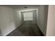 A spacious bedroom features plush carpeting, neutral paint, and a window providing natural light at 3112 Star Gazing Ln, Durham, NC 27703