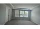 Bright bedroom with large windows, neutral walls, and plush gray carpet at 3112 Star Gazing Ln, Durham, NC 27703
