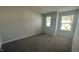 Bright bedroom featuring neutral walls, plush carpet, and dual windows with pleasant outdoor views at 3112 Star Gazing Ln, Durham, NC 27703