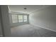 Bedroom featuring neutral walls, plush carpet, and windows allowing ample natural light to fill the space at 3112 Star Gazing Ln, Durham, NC 27703