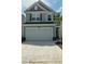 Charming two-story home featuring a two-car garage, gray siding and decorative shutters at 3112 Star Gazing Ln, Durham, NC 27703