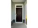 Stylish, dark-stained front door with modern hardware and decorative stone accents at 3112 Star Gazing Ln, Durham, NC 27703