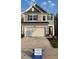 Well-maintained two-story home with a spacious driveway and charming architectural details at 3112 Star Gazing Ln, Durham, NC 27703