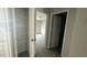 Hallway with closet and view into carpeted bedroom, providing storage solutions and comfortable living space at 3112 Star Gazing Ln, Durham, NC 27703