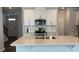 Beautiful kitchen island with modern fixtures, stainless steel appliances and white cabinetry at 3112 Star Gazing Ln, Durham, NC 27703