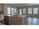 Bright, open-concept kitchen featuring a center island and stainless steel appliances and dark wood floors at 3112 Star Gazing Ln, Durham, NC 27703