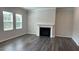 Cozy living room featuring a modern fireplace, hardwood floors and large windows at 3112 Star Gazing Ln, Durham, NC 27703