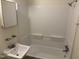 Full bathroom including a sink, mirror, tub, and shower head at 317 Gary St, Durham, NC 27703