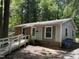 Quaint single-story home with a mix of brick and siding, complemented by lush greenery at 317 Gary St, Durham, NC 27703