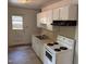 Functional kitchen with appliances, cabinetry, and a door to the backyard at 317 Gary St, Durham, NC 27703