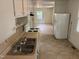 Kitchen view including appliances, cabinetry, and view of living room at 317 Gary St, Durham, NC 27703