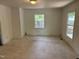 Bright living room featuring a window, neutral walls, and durable flooring at 317 Gary St, Durham, NC 27703