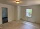 Bright living room featuring a window, neutral walls, and durable flooring at 317 Gary St, Durham, NC 27703
