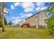 Spacious backyard featuring a well-maintained lawn, wooden fence, and a two-story home with a red wooden deck at 32 Lattimore Rd, Cameron, NC 28326