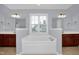 Bright and spacious bathroom with a garden tub, double sinks, and a large window for natural light at 32 Lattimore Rd, Cameron, NC 28326