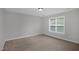 Comfortable bedroom with neutral carpeting and a bright window for natural light at 32 Lattimore Rd, Cameron, NC 28326