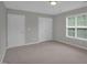 Bedroom includes neutral carpet, window, and 2 closets at 32 Lattimore Rd, Cameron, NC 28326