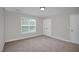 Neutral bedroom featuring carpet, a window, and a closet door at 32 Lattimore Rd, Cameron, NC 28326