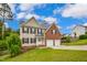 Two-story home showcasing a combination of brick and siding, complemented by a green lawn at 32 Lattimore Rd, Cameron, NC 28326