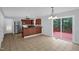 Open kitchen and dining area featuring modern appliances, granite countertops, and sliding glass doors to the deck at 32 Lattimore Rd, Cameron, NC 28326