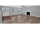 Bright living room featuring a fireplace, modern flooring, and a view of the front door at 32 Lattimore Rd, Cameron, NC 28326